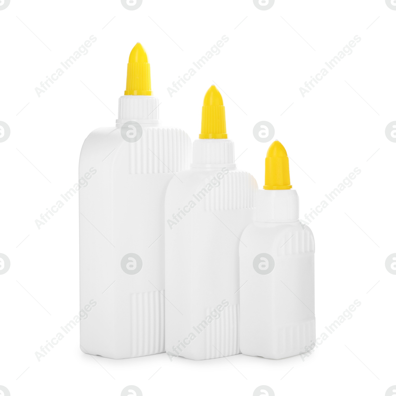 Photo of Bottles of glue with caps isolated on white