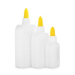 Photo of Bottles of glue with caps isolated on white