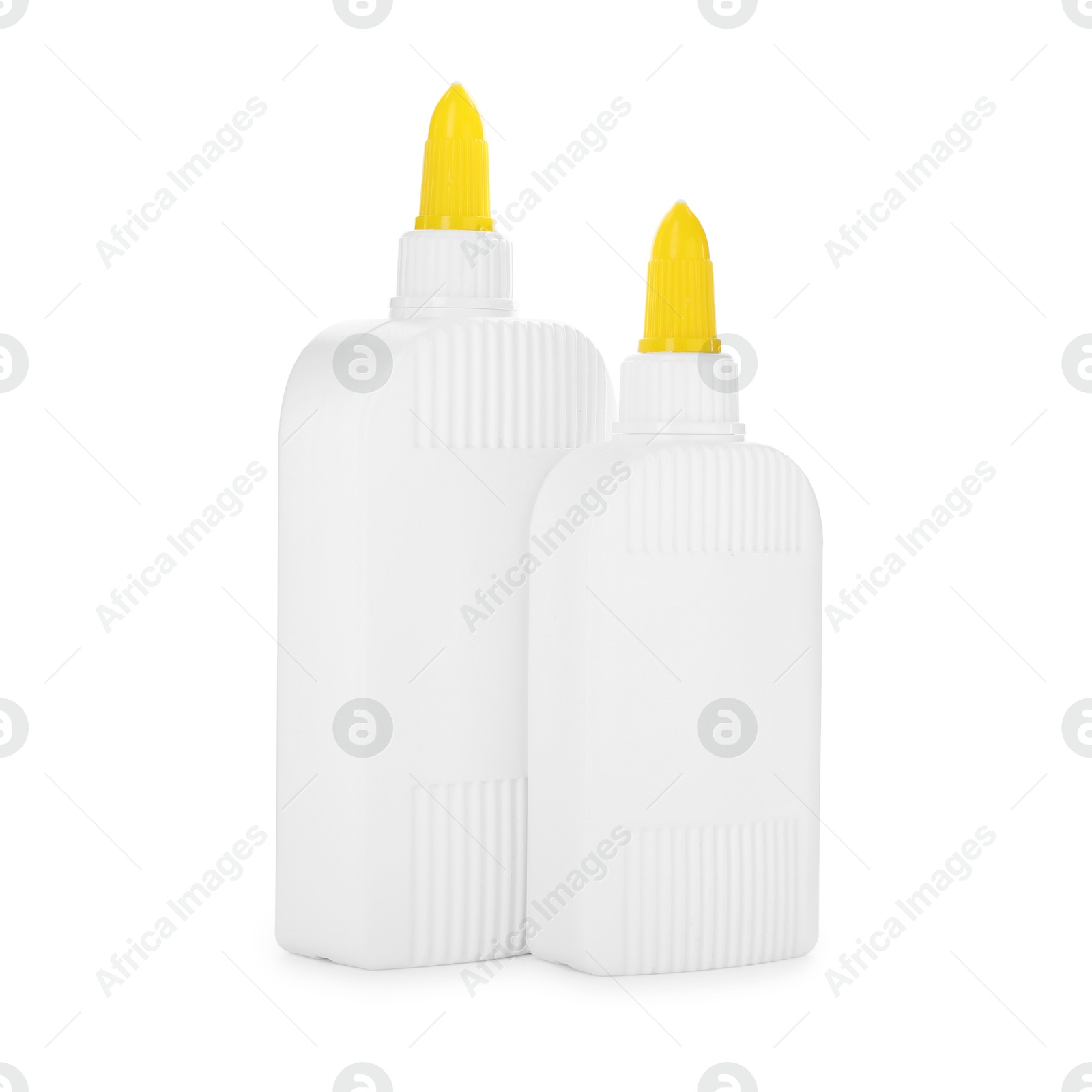 Photo of Bottles of glue with caps isolated on white