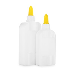 Photo of Bottles of glue with caps isolated on white