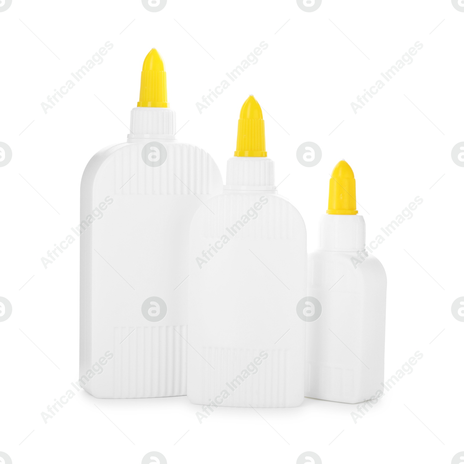 Photo of Bottles of glue with caps isolated on white