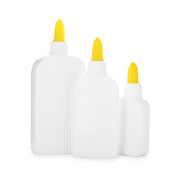 Photo of Bottles of glue with caps isolated on white