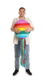 Photo of Happy man with colorful pinata on white background