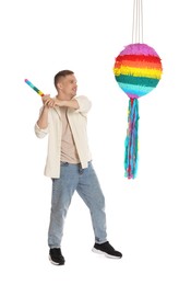 Happy man breaking pinata on white background