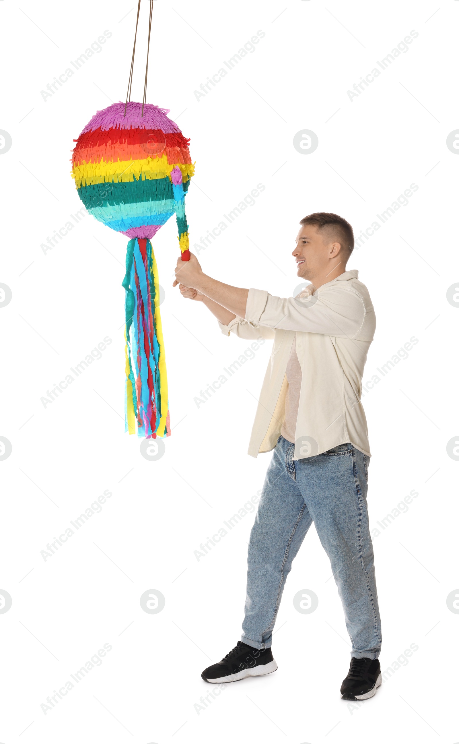 Photo of Happy man breaking pinata on white background