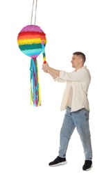 Happy man breaking pinata on white background