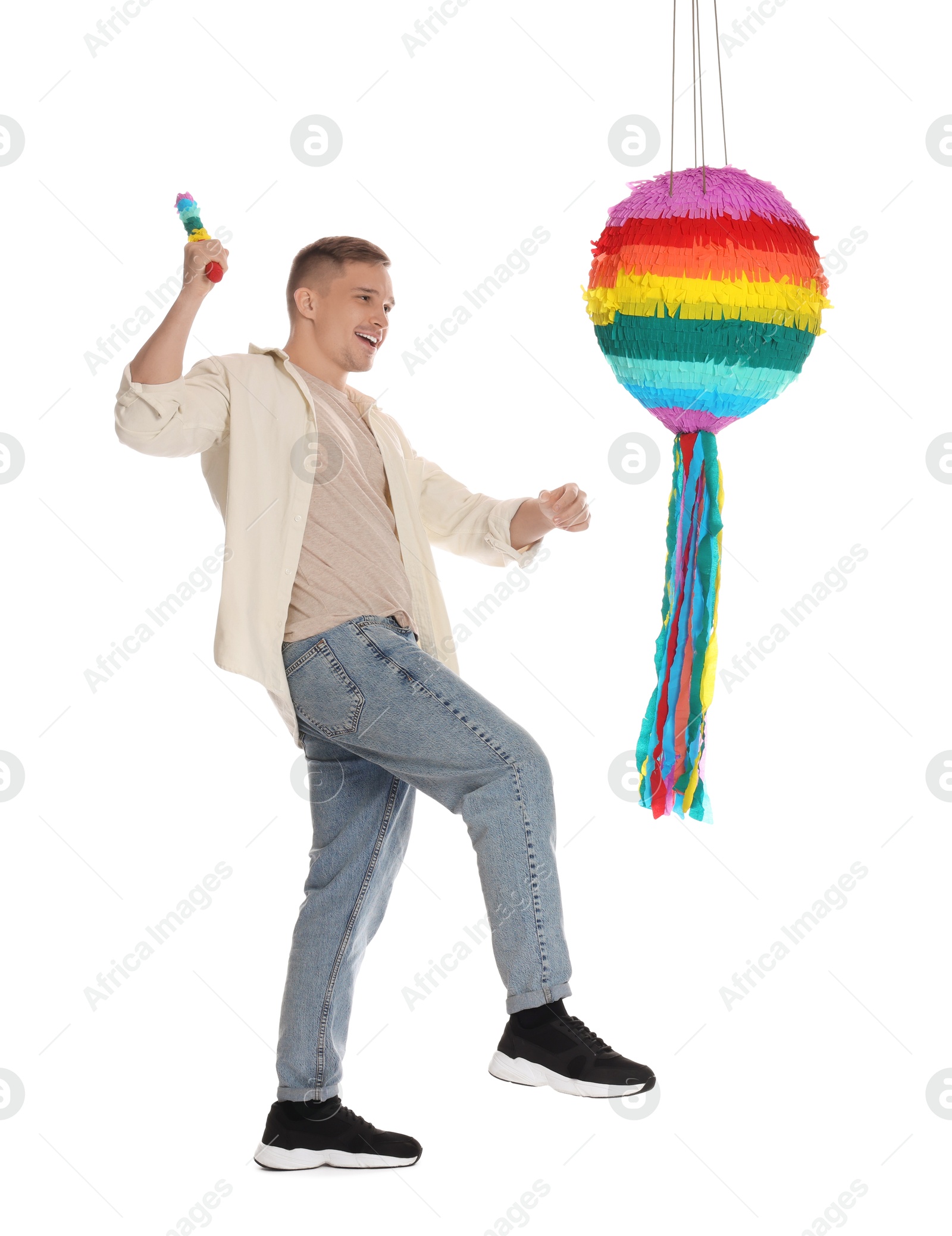 Photo of Happy man breaking pinata on white background