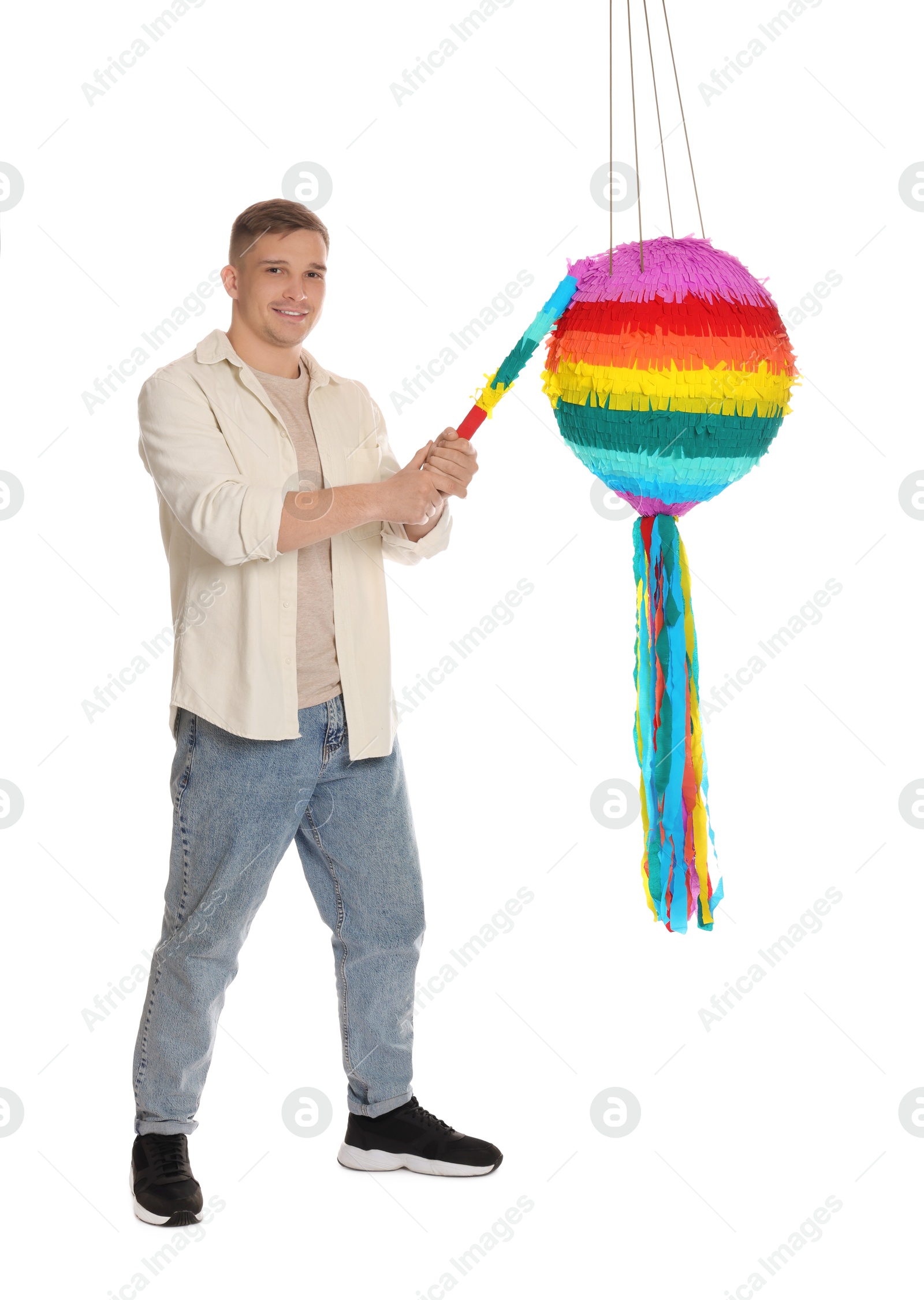 Photo of Happy man breaking pinata on white background