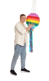 Photo of Happy man with colorful pinata on white background