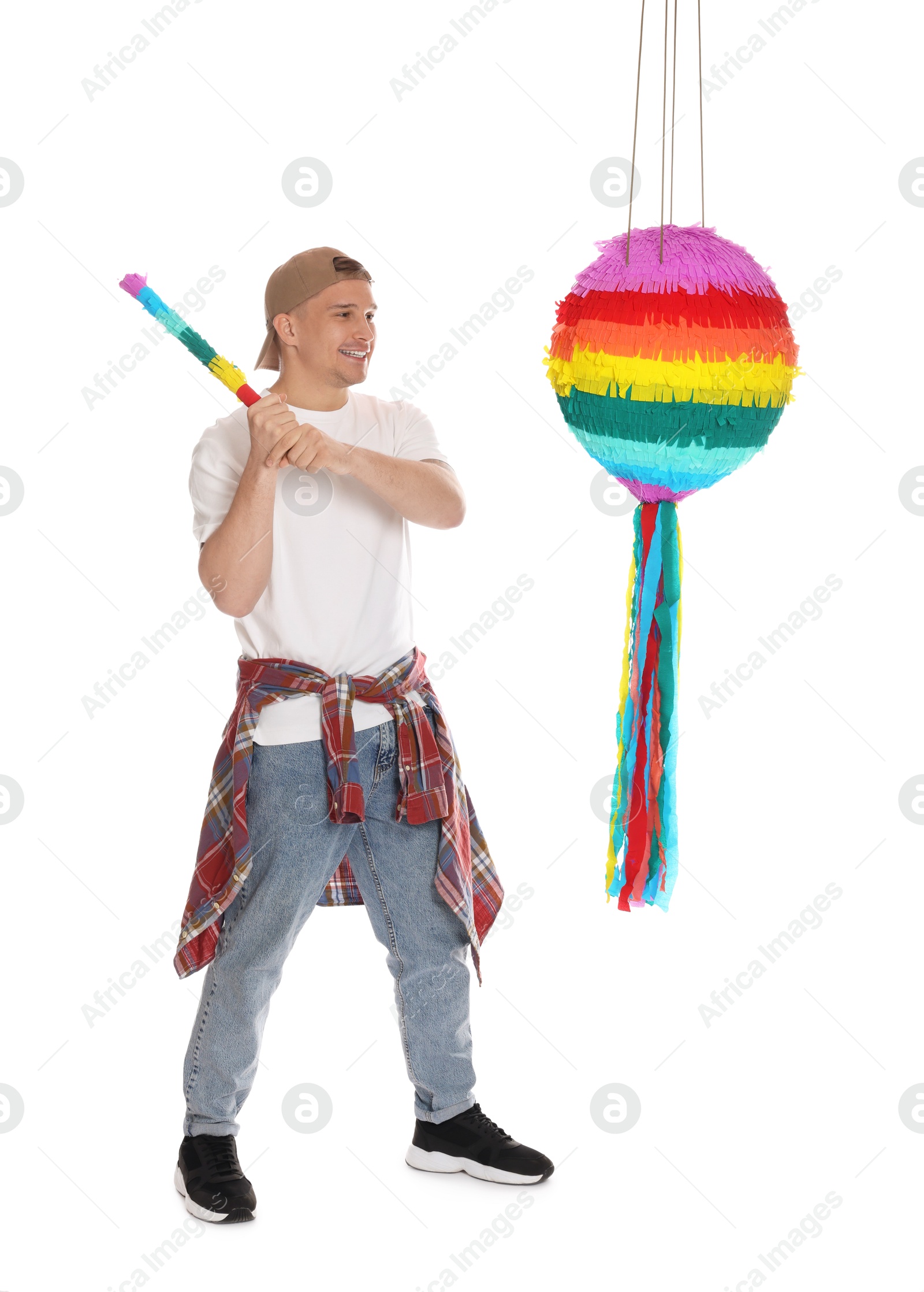 Photo of Happy man breaking pinata on white background