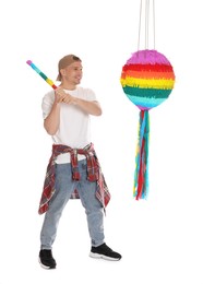 Photo of Happy man breaking pinata on white background