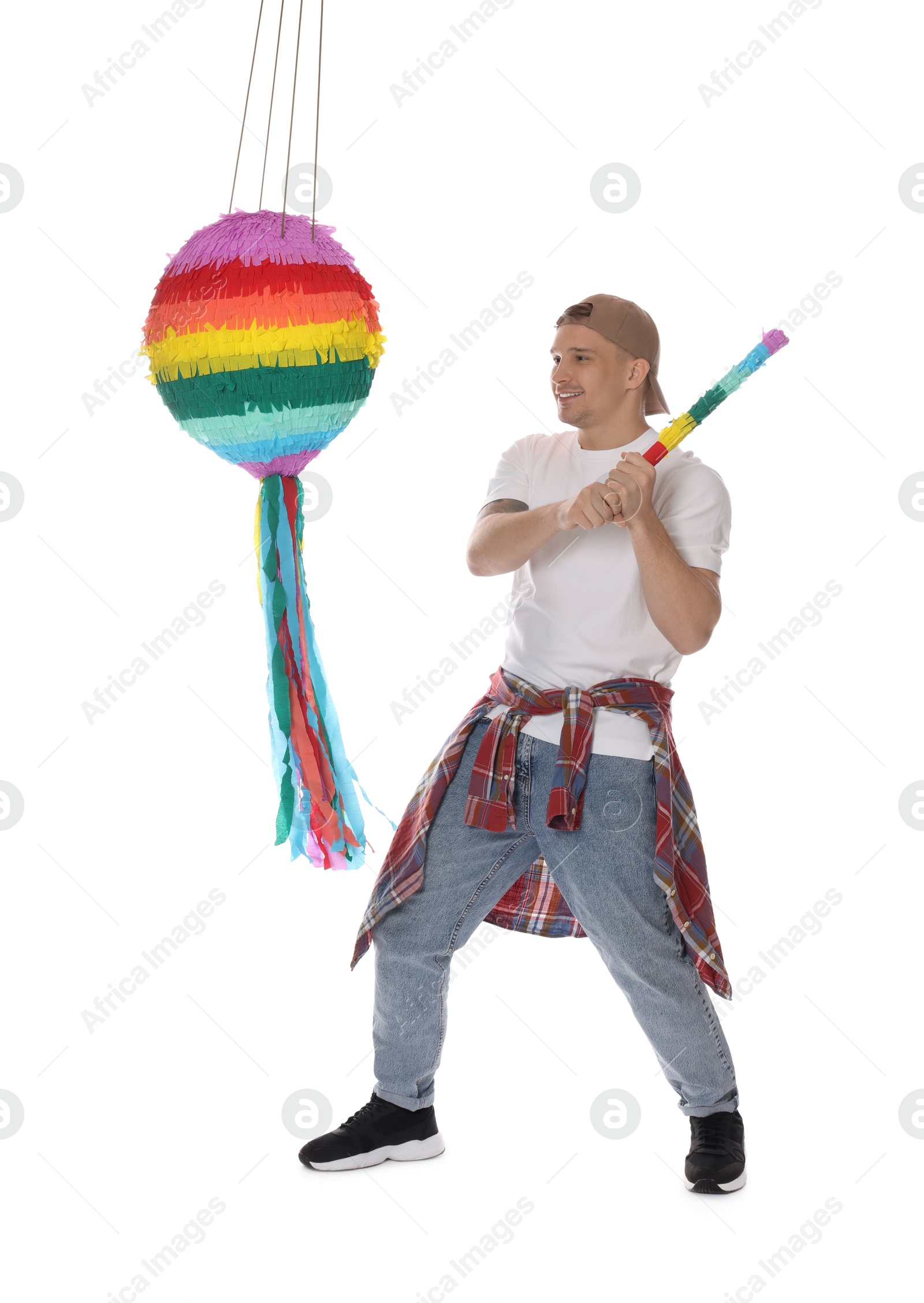 Photo of Happy man breaking pinata on white background