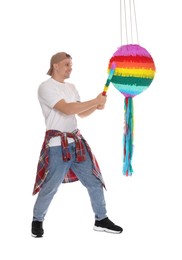 Photo of Happy man breaking pinata on white background