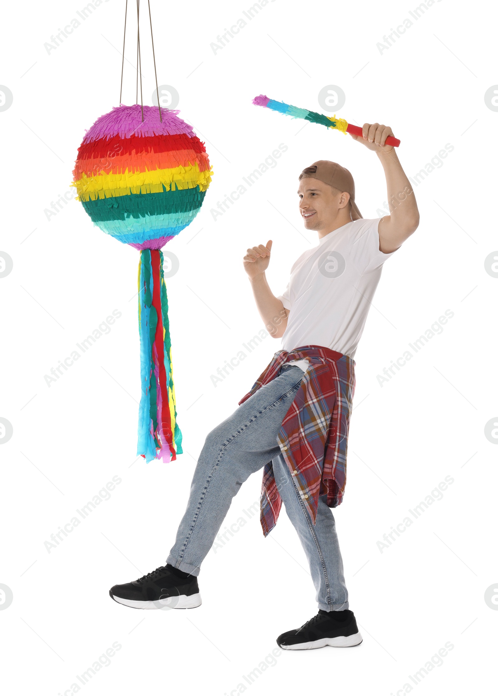 Photo of Happy man breaking pinata on white background