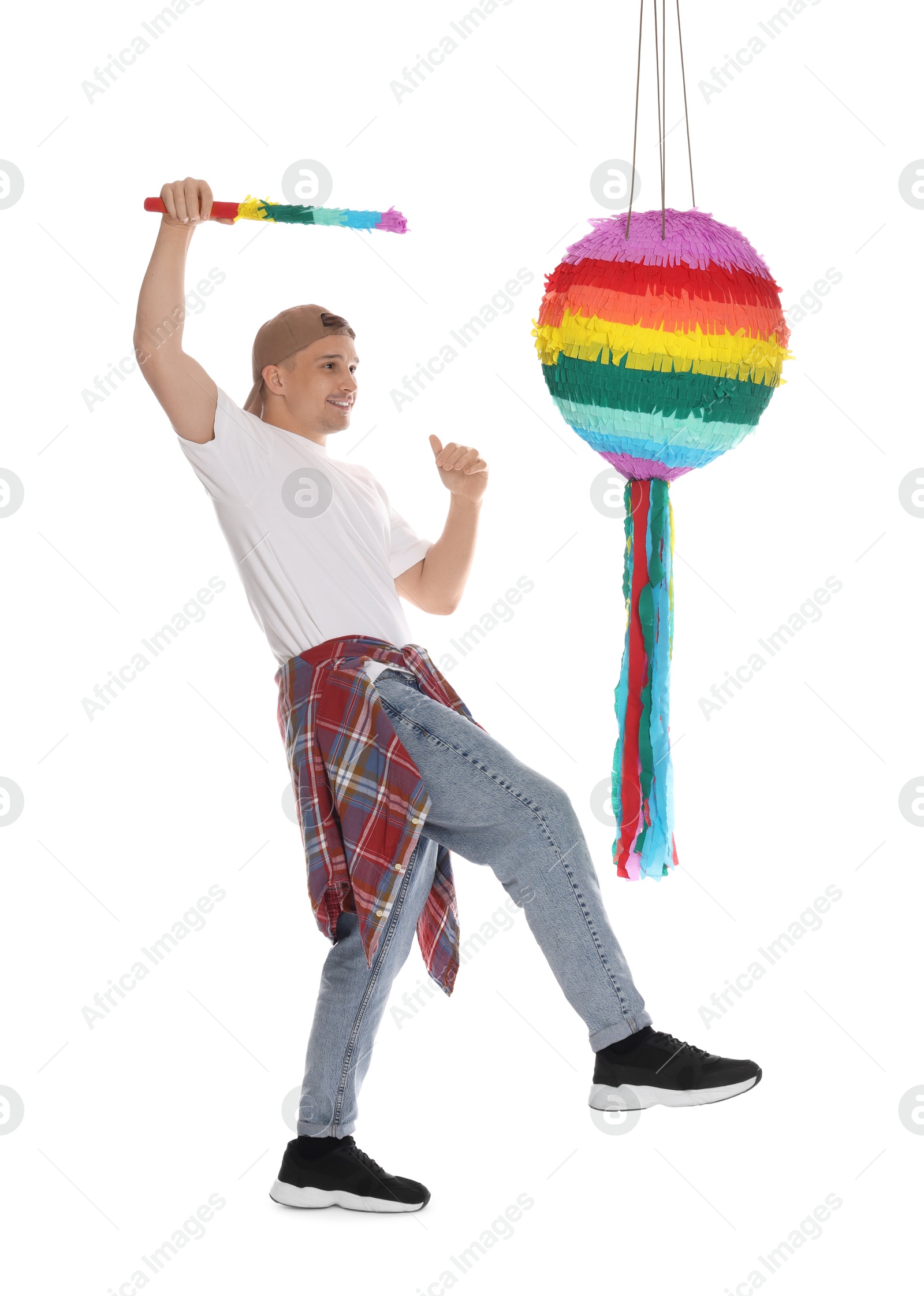 Photo of Happy man breaking pinata on white background