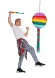 Photo of Happy man breaking pinata on white background