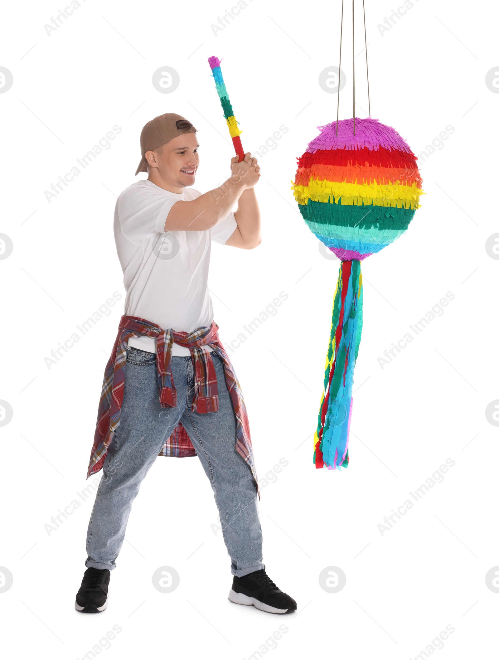 Photo of Happy man breaking pinata on white background