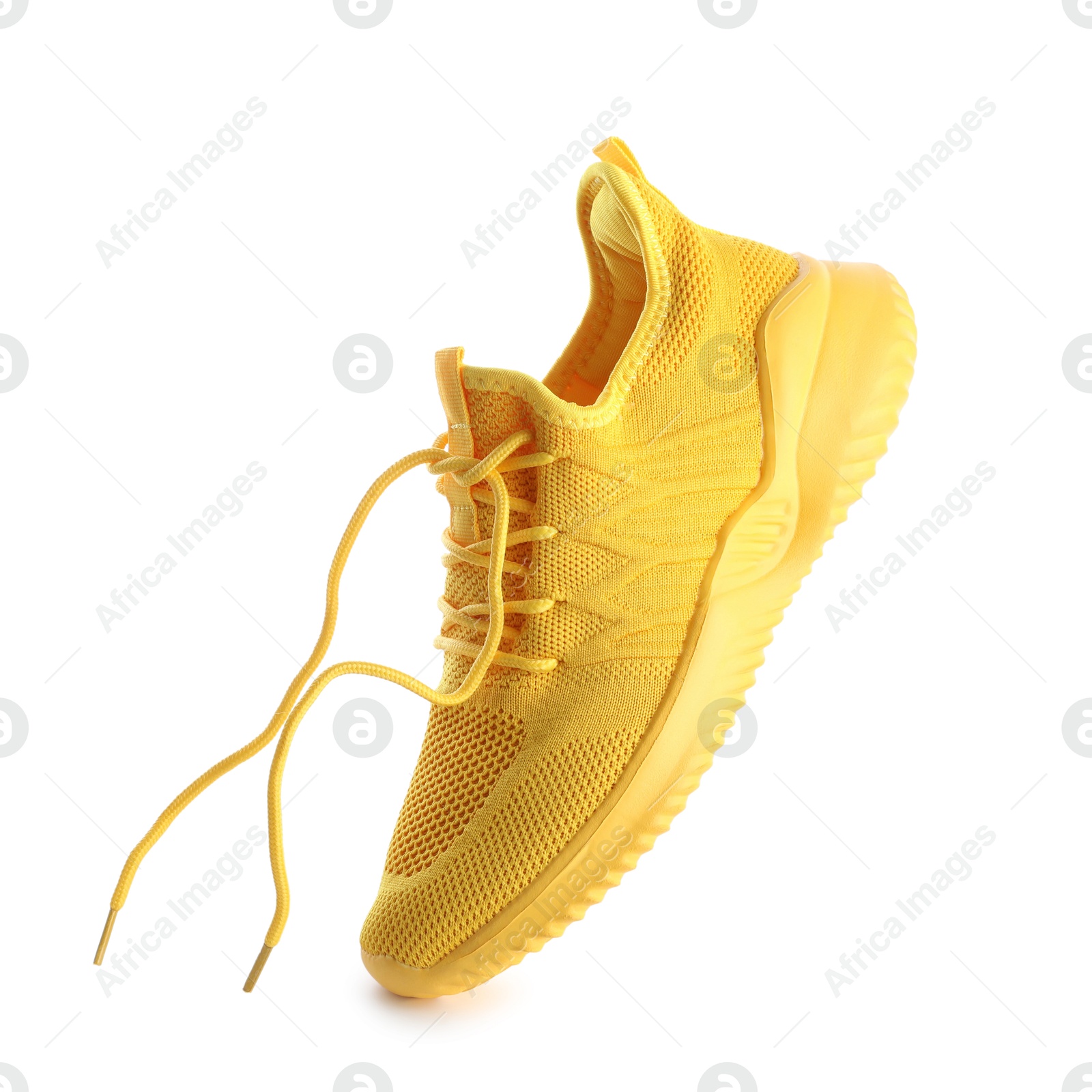 Photo of One stylish yellow sneaker isolated on white