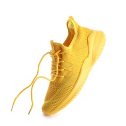 Photo of One stylish yellow sneaker isolated on white