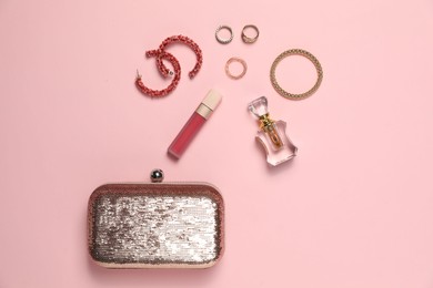 Photo of Many stylish jewelry, perfume and accessories on pink background, flat lay