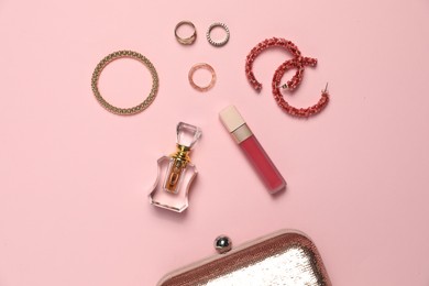 Photo of Many stylish jewelry and accessories on pink background, flat lay