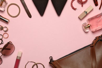 Photo of Frame made of many stylish jewelry, perfume, shoes and accessories on pink background, flat lay. Space for text