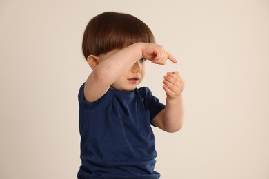 Photo of Cute little boy on light grey background