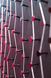 Photo of Network connection. Nails linked together by thread on black background, closeup