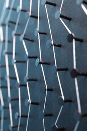 Photo of Network connection. Nails linked together by thread on black background, closeup