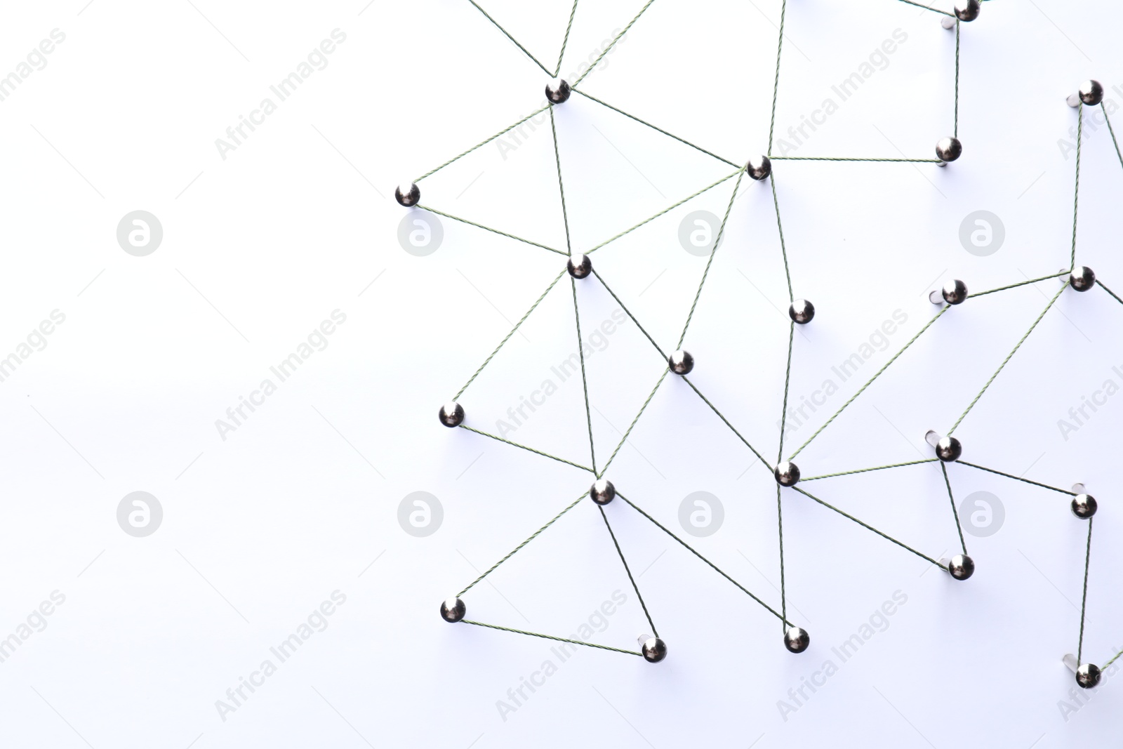 Photo of Network connection. Nails linked together by threads on white background, flat lay. Space for text