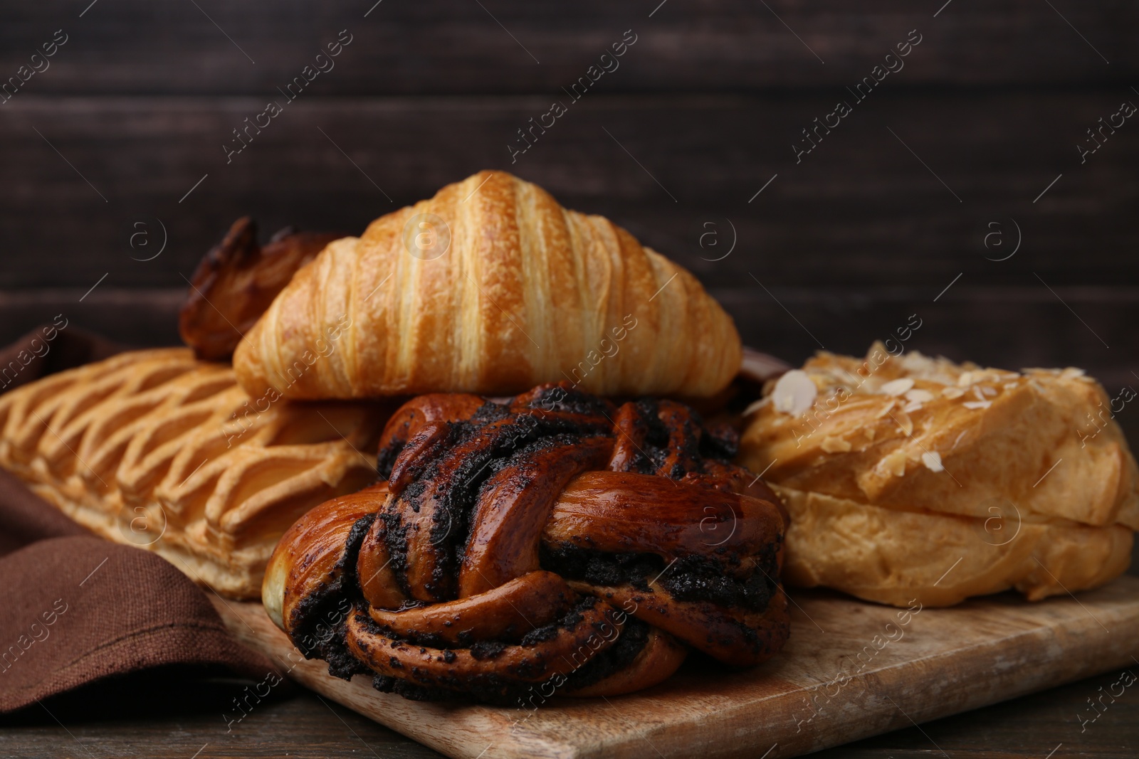 Photo of Different sweet pastries on wooden table, closeup