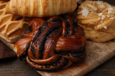 Photo of Different sweet pastries on wooden table, closeup