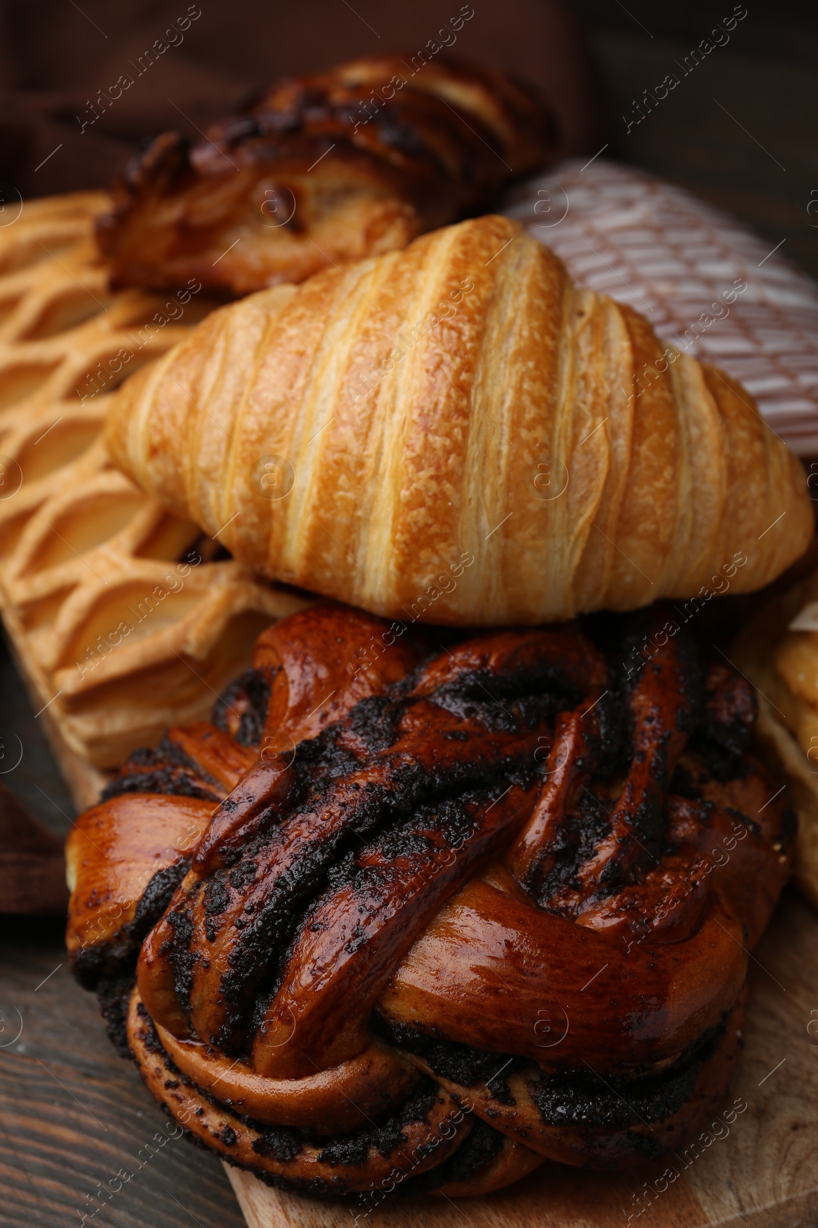 Photo of Different sweet pastries on wooden table, closeup