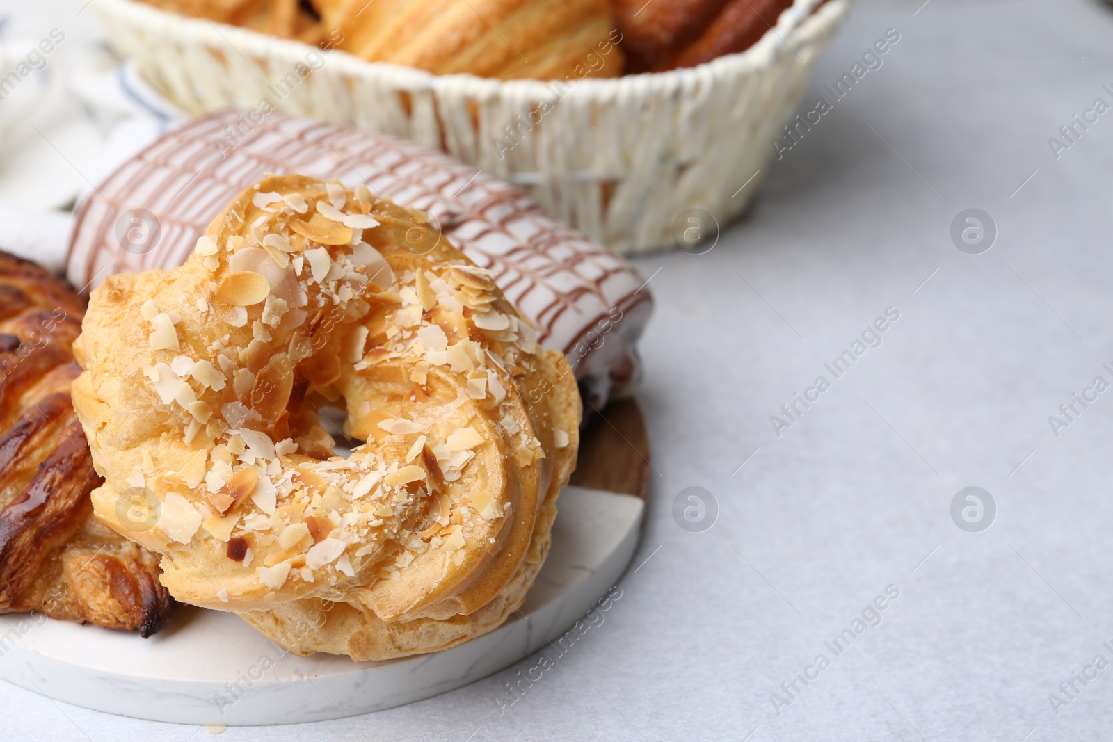 Photo of Different sweet pastries on light table, closeup. Space for text