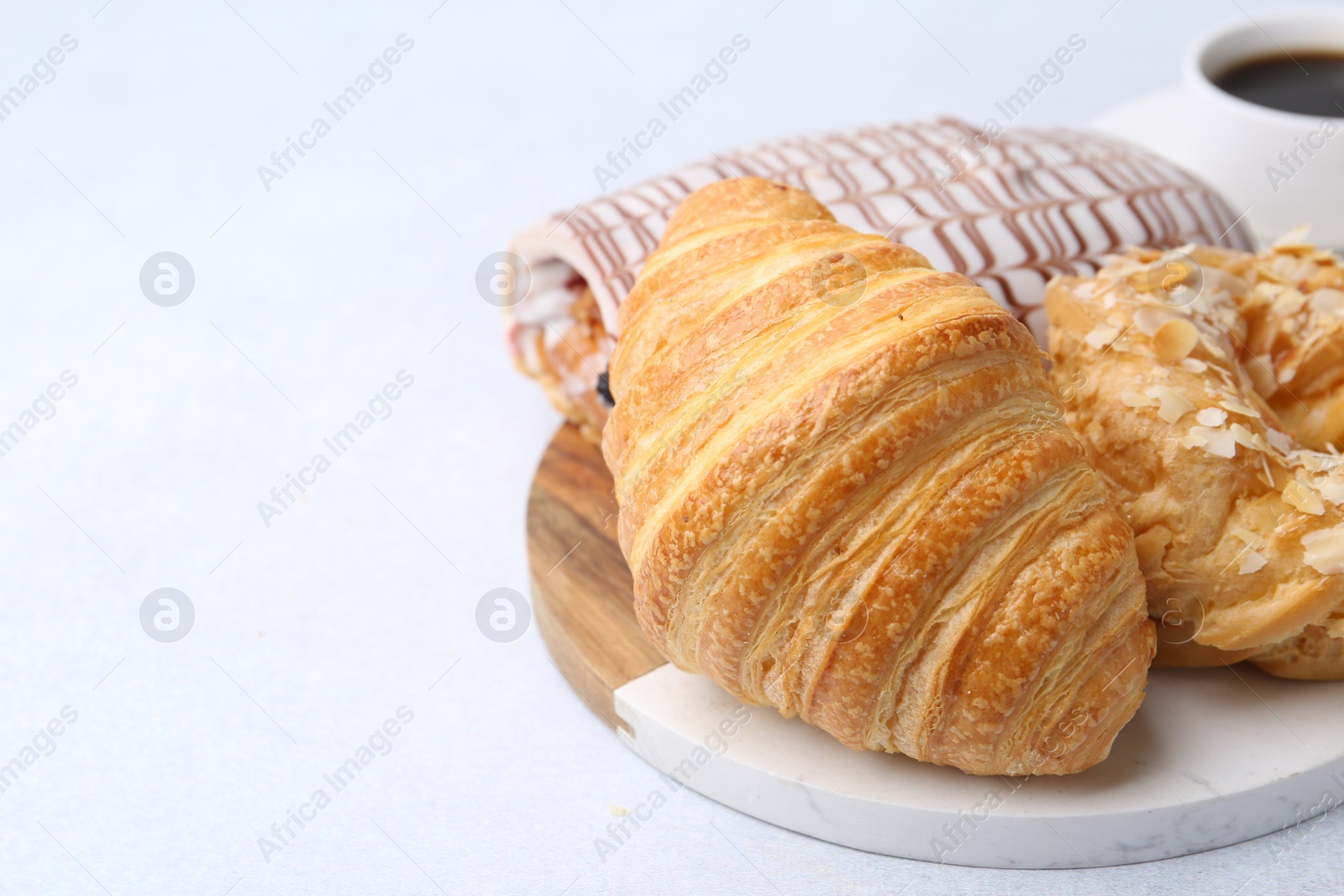 Photo of Different sweet pastries on light table, closeup. Space for text