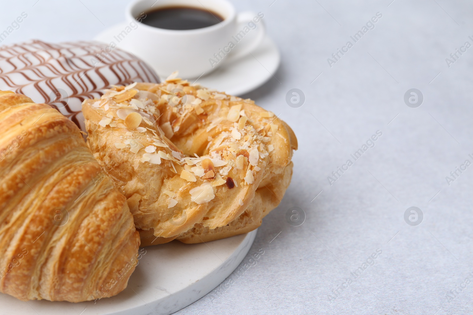 Photo of Different sweet pastries on light table, closeup. Space for text