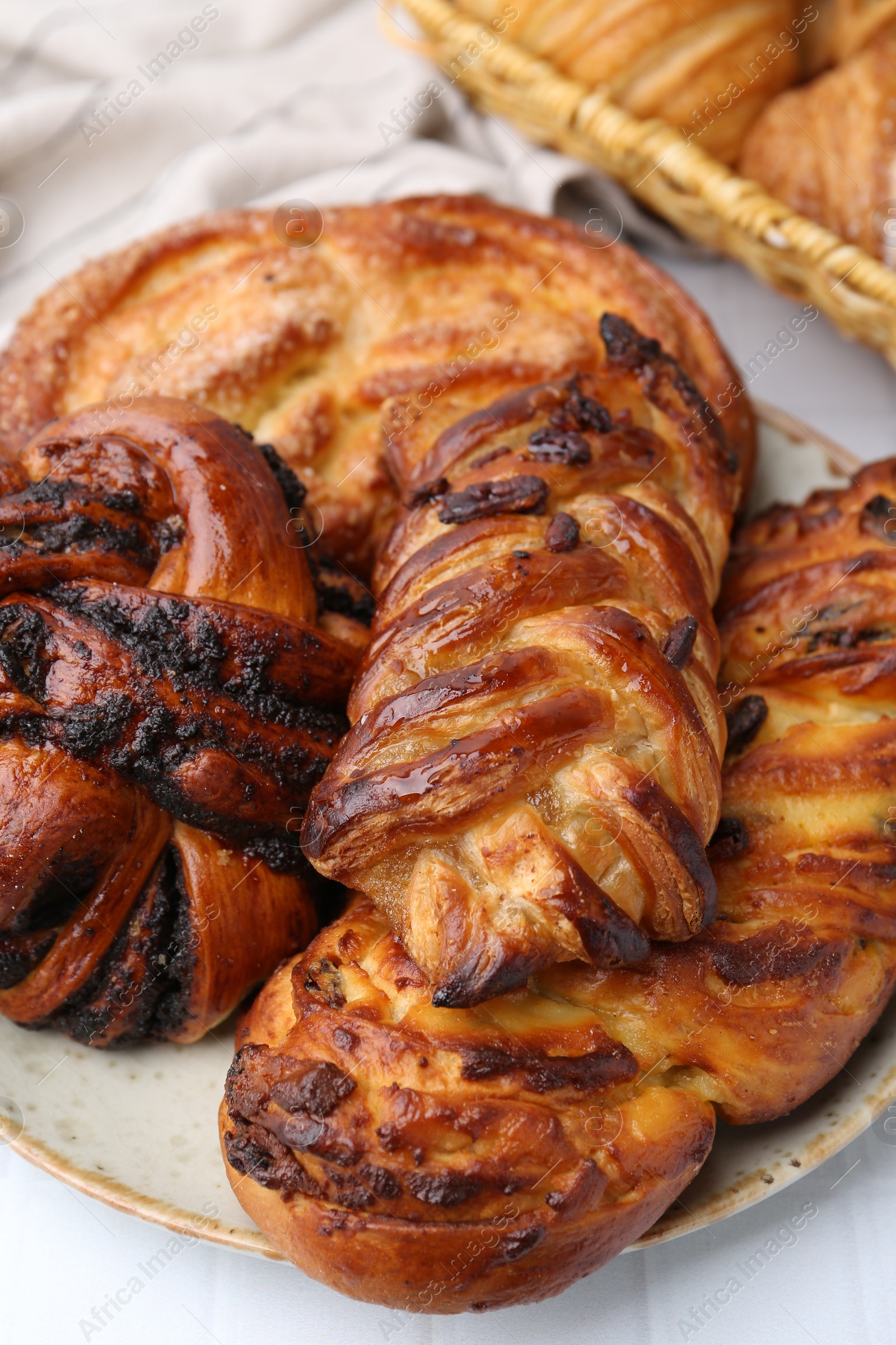 Photo of Different sweet pastries on white tiled table, closeup