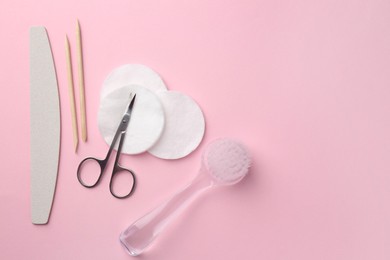 Photo of Set of pedicure tools on pink background, flat lay. Space for text