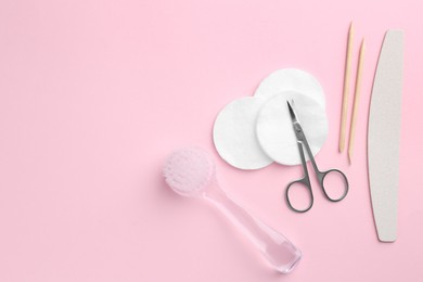 Photo of Set of pedicure tools on pink background, flat lay. Space for text