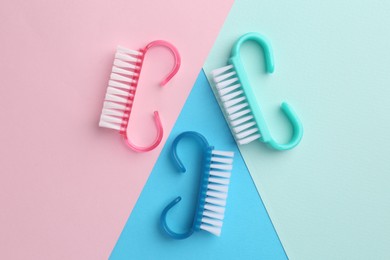 Photo of Pedicure procedure. Different brushes on color background, flat lay