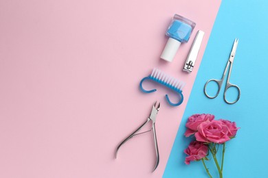 Photo of Set of pedicure tools and flowers on color background, flat lay. Space for text