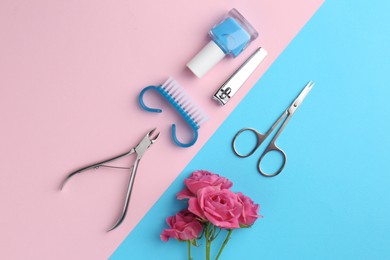 Photo of Set of pedicure tools and flowers on color background, flat lay