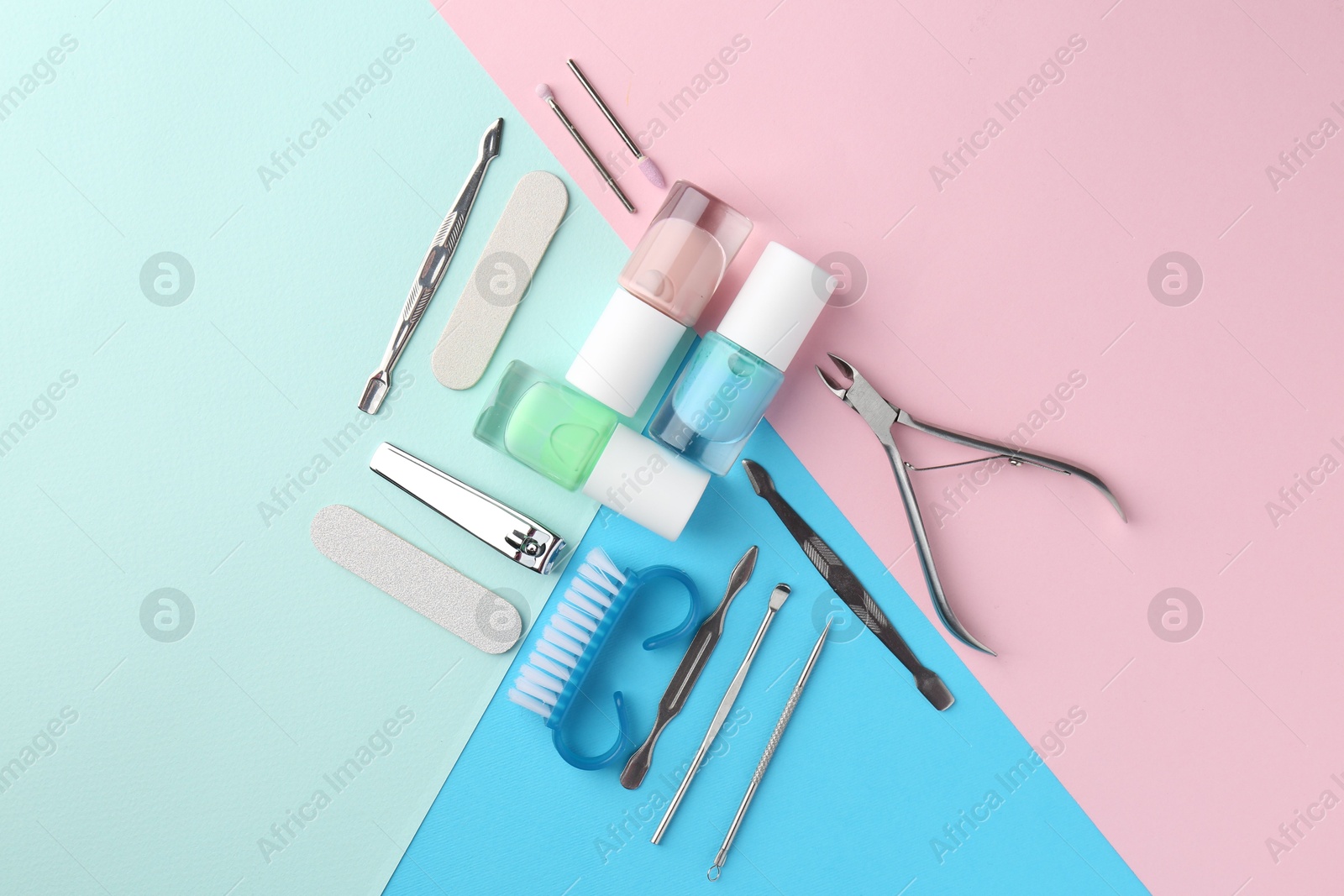 Photo of Set of pedicure tools on color background, flat lay