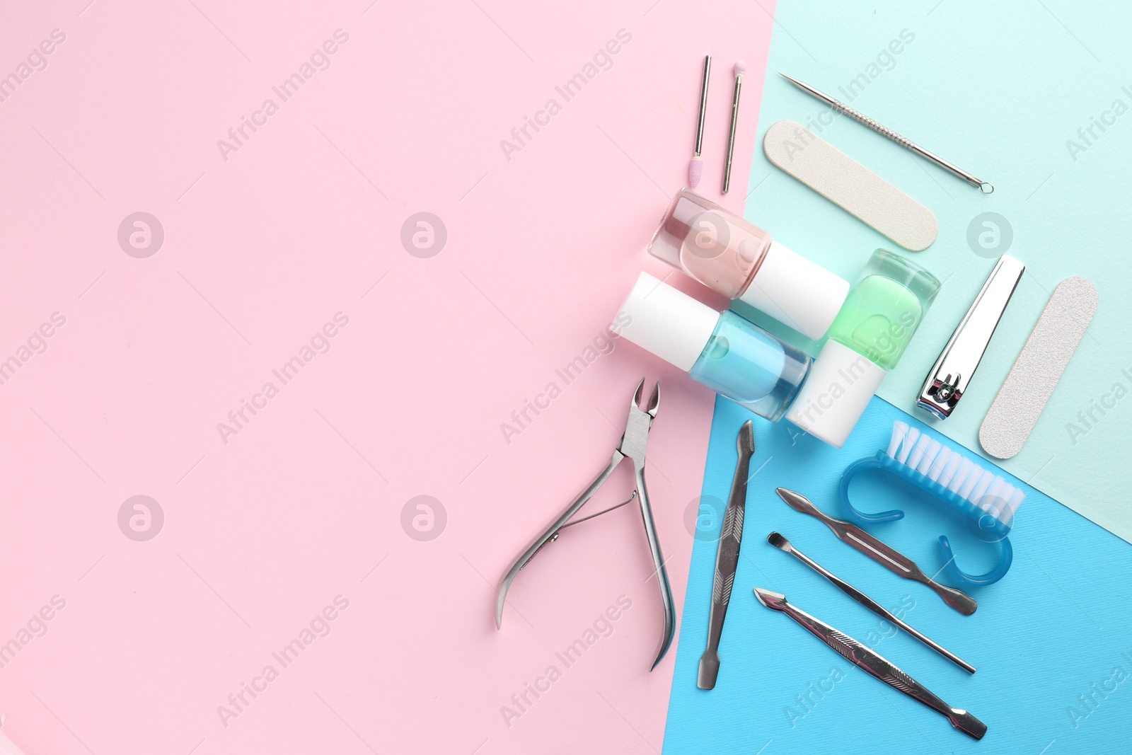 Photo of Set of pedicure tools on color background, flat lay. Space for text