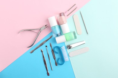 Photo of Set of pedicure tools on color background, flat lay