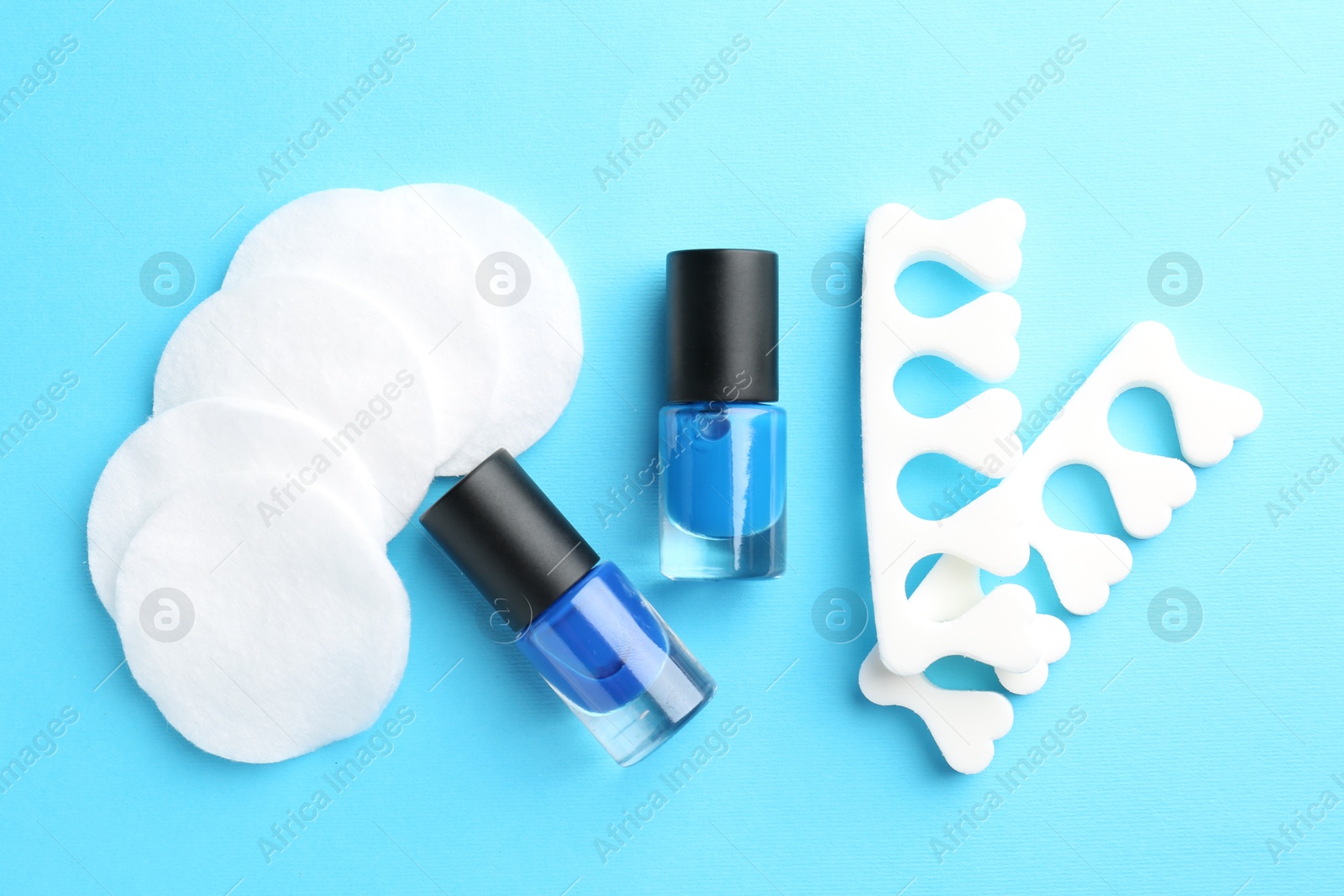 Photo of Set of pedicure tools on light blue background, flat lay