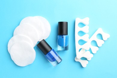 Photo of Set of pedicure tools on light blue background, flat lay