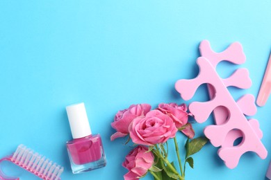 Photo of Set of pedicure tools on light blue background, flat lay. Space for text