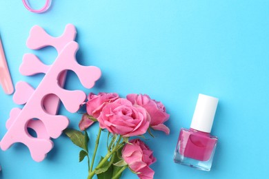 Photo of Set of pedicure tools on light blue background, flat lay. Space for text