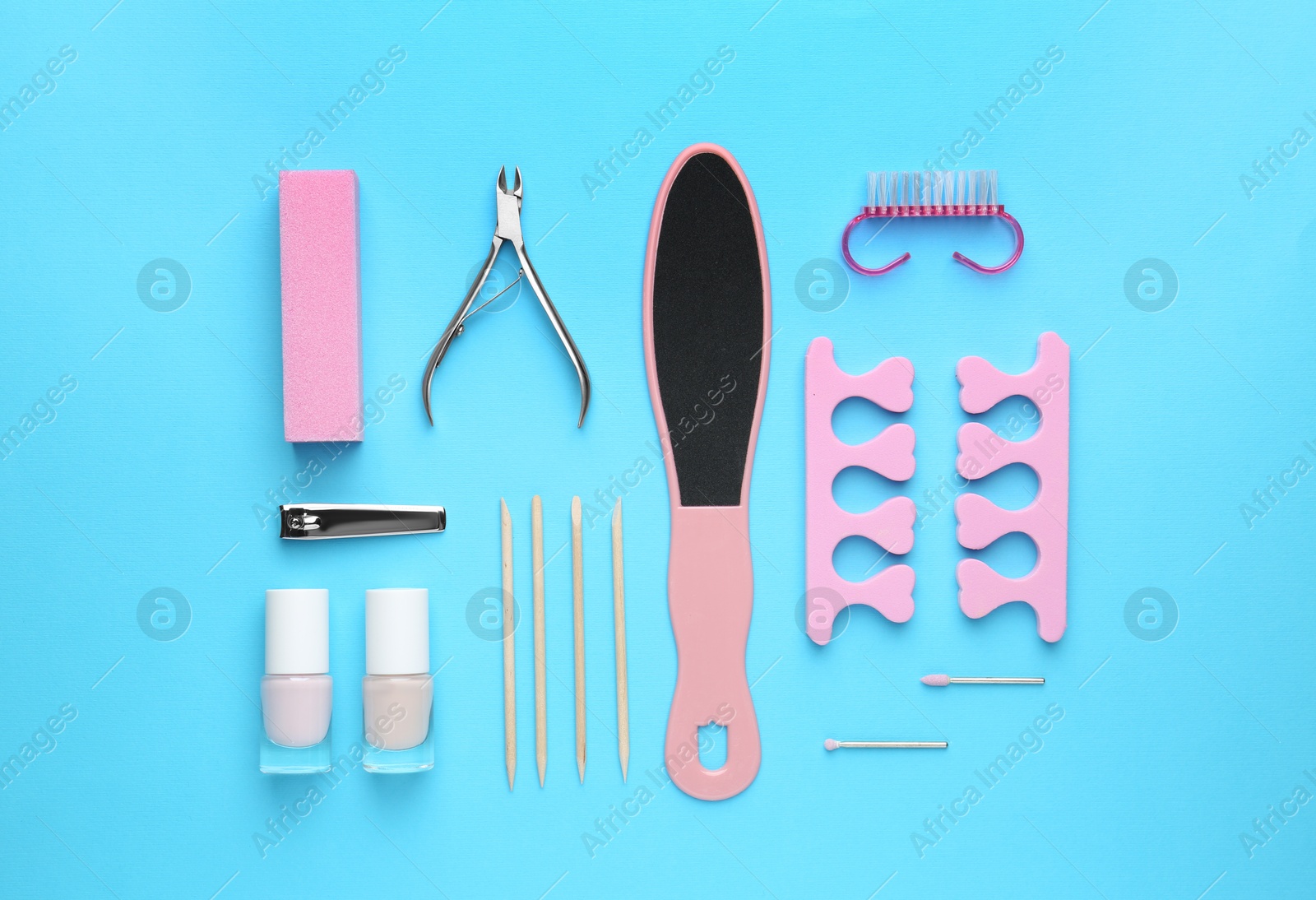 Photo of Set of pedicure tools on light blue background, flat lay